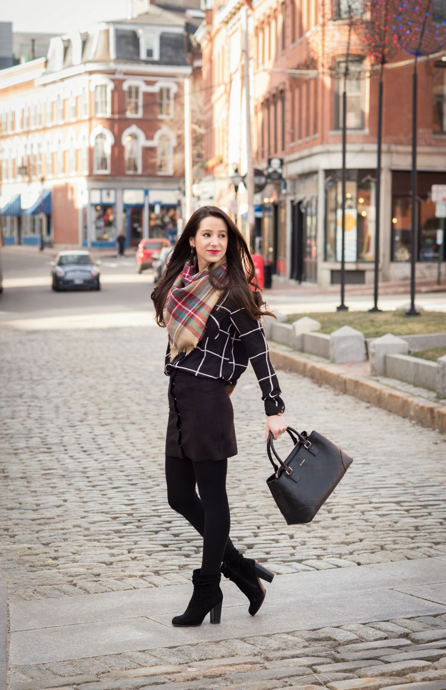 Chic all black winter outfit with a pop of color in the scarf