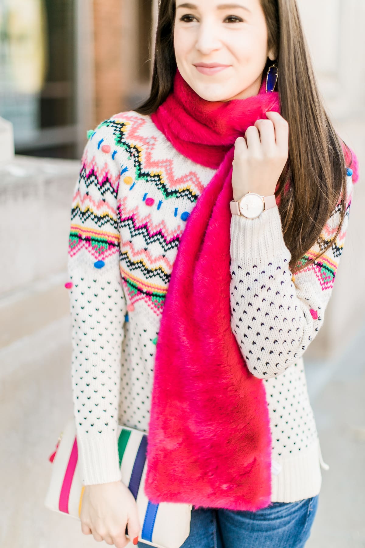 Colorful Christmas sweater ideas from Talbots, featuring their Carnival Fair Isle Sweater, Pink Faux Fur Pull Through Scarf, and Canvas Stripe Makeup Pouch styled with AG the Legging ankle jeans, taupe Free People Liberty boots, and cognac Kendra Scott Skylar earrings by southern fashion blogger Stephanie Ziajka from Diary of a Debutante