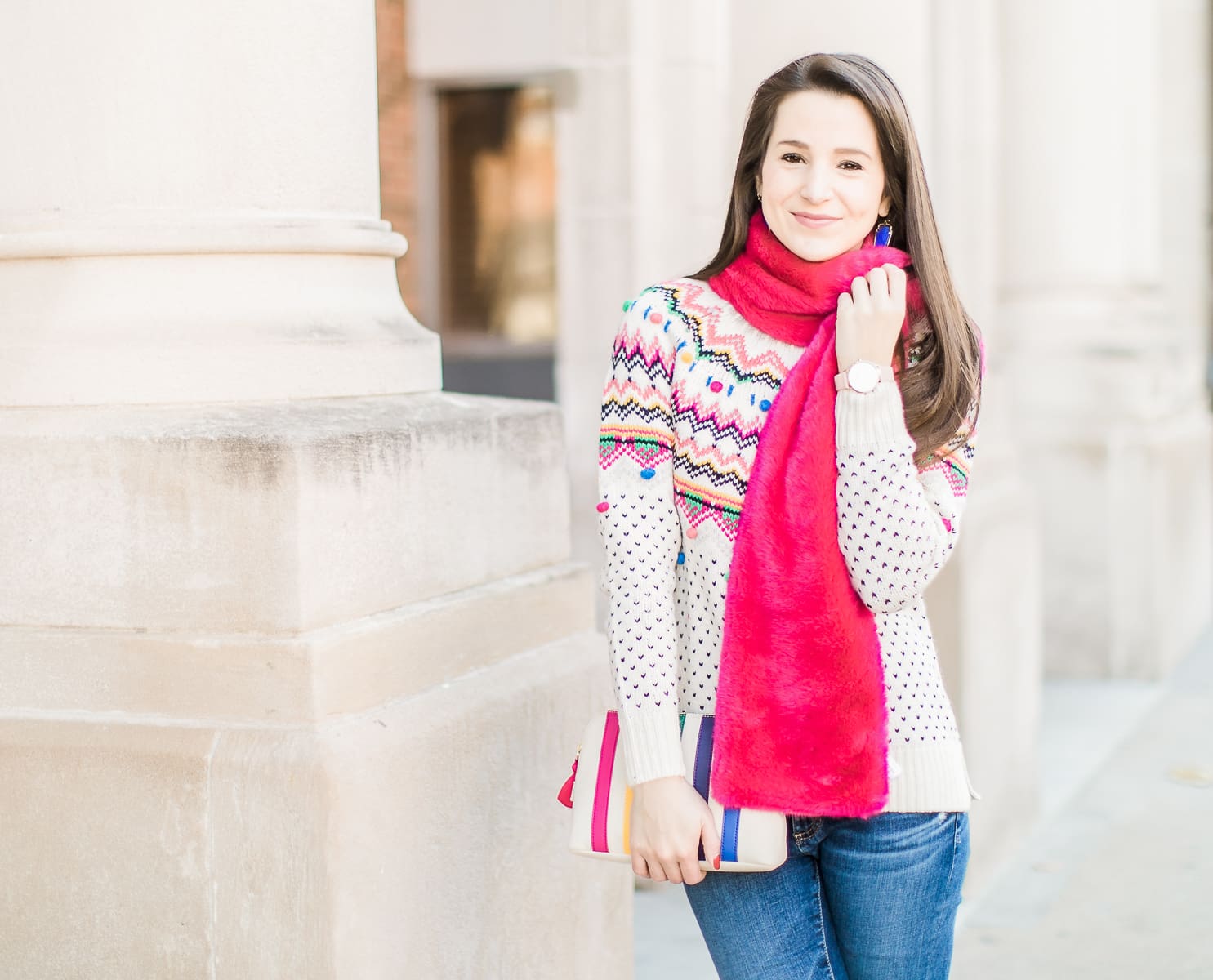 Colorful Christmas sweater ideas from Talbots, featuring their Carnival Fair Isle Sweater, Pink Faux Fur Pull Through Scarf, and Canvas Stripe Makeup Pouch styled with AG the Legging ankle jeans, taupe Free People Liberty boots, and cognac Kendra Scott Skylar earrings by southern fashion blogger Stephanie Ziajka from Diary of a Debutante
