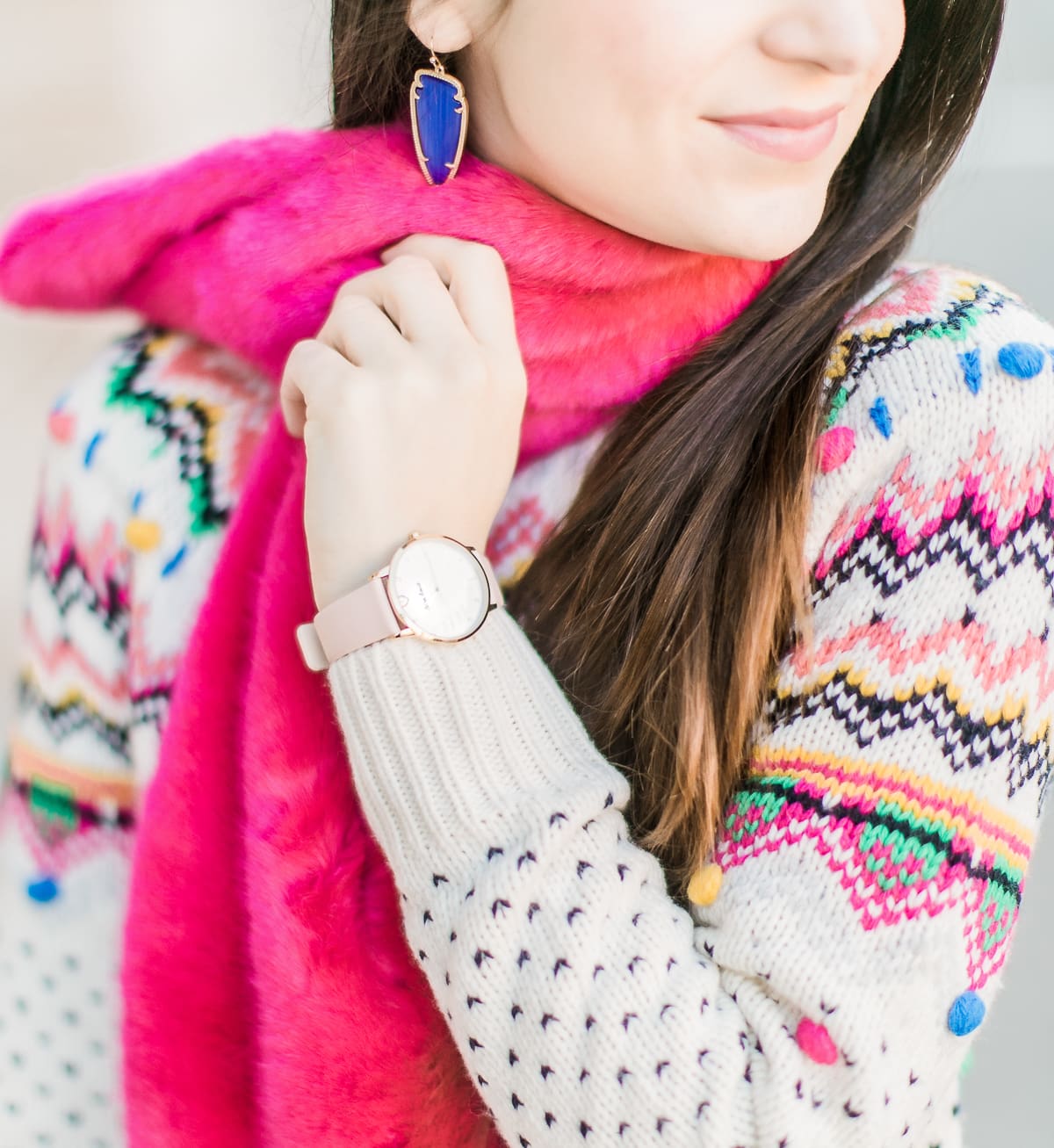 Colorful Christmas sweater ideas from Talbots, featuring their Carnival Fair Isle Sweater, Pink Faux Fur Pull Through Scarf, and Canvas Stripe Makeup Pouch styled with AG the Legging ankle jeans, taupe Free People Liberty boots, and cognac Kendra Scott Skylar earrings by southern fashion blogger Stephanie Ziajka from Diary of a Debutante