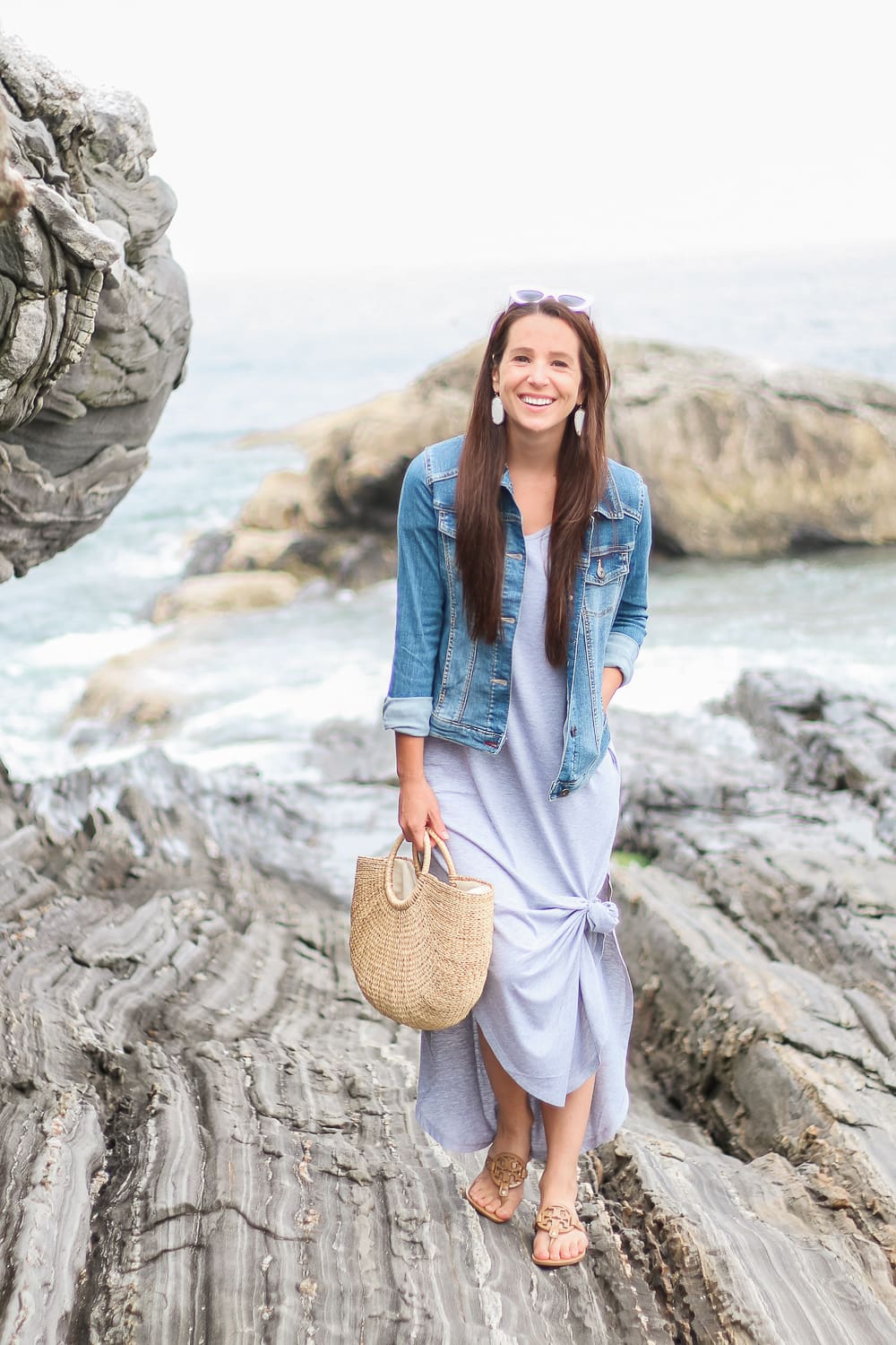 Amazon Fashion split hem gray maxi dress styled with Wranglers Authentic stretch denim jacket, Amazon Fashion round handle straw handbag, sand Tory Burch Miller Sandals and white cat eye sunglasses by popular affordable fashion blogger Stephanie Ziajka on Diary of a Debutante, Pemaquid Point photos, dress with denim jacket, denim jacket maxi dress, how to wear a denim jacket