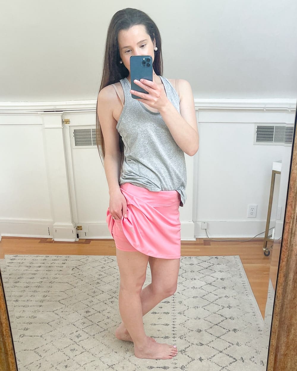 Affordable fashion blogger Stephanie Ziajka shows off the built-in shorts in her Amazon hot pink golf skirt on Diary of a Debutante