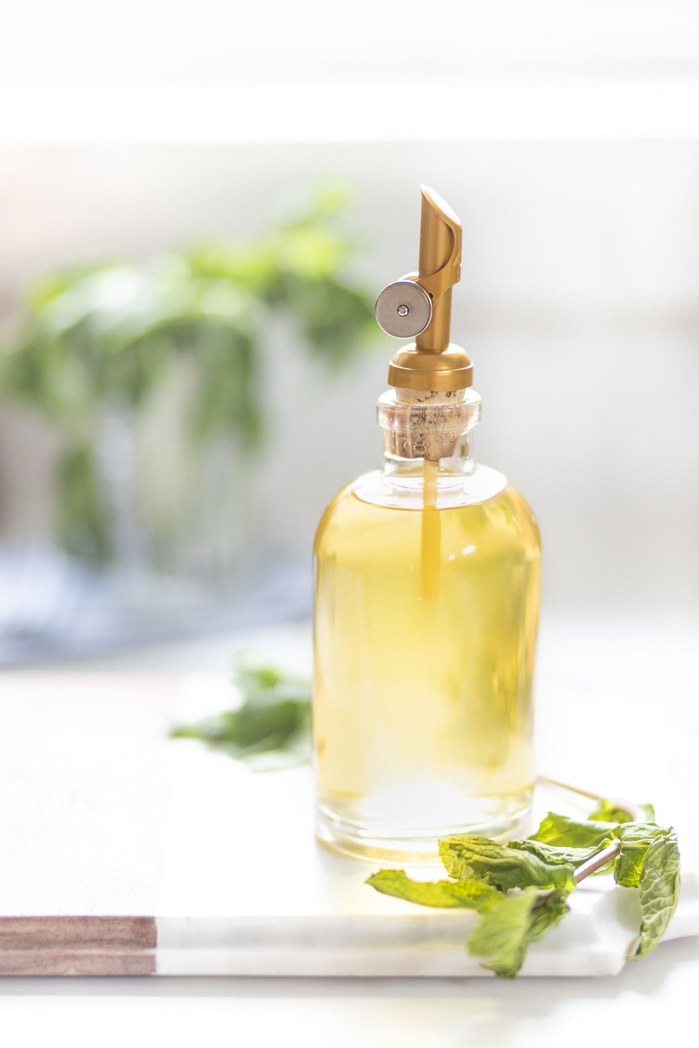 Mint flavored simple syrup in a glass jar with gold spout on Diary of a Debutante Mint flavored simple syrup in a glass jar with gold spout on Diary of a Debutante