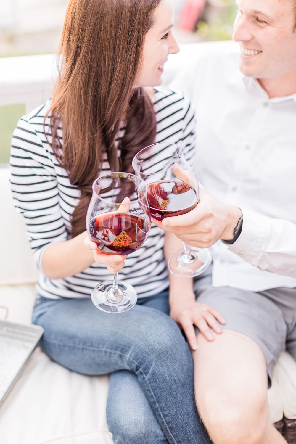 couple drinking red wine on the popular affordable entertaining blog Diary of a Debutante, Yealands Pinot Noir wine, cheers couple drinking red wine on the popular affordable entertaining blog Diary of a Debutante, Yealands Pinot Noir wine, cheers