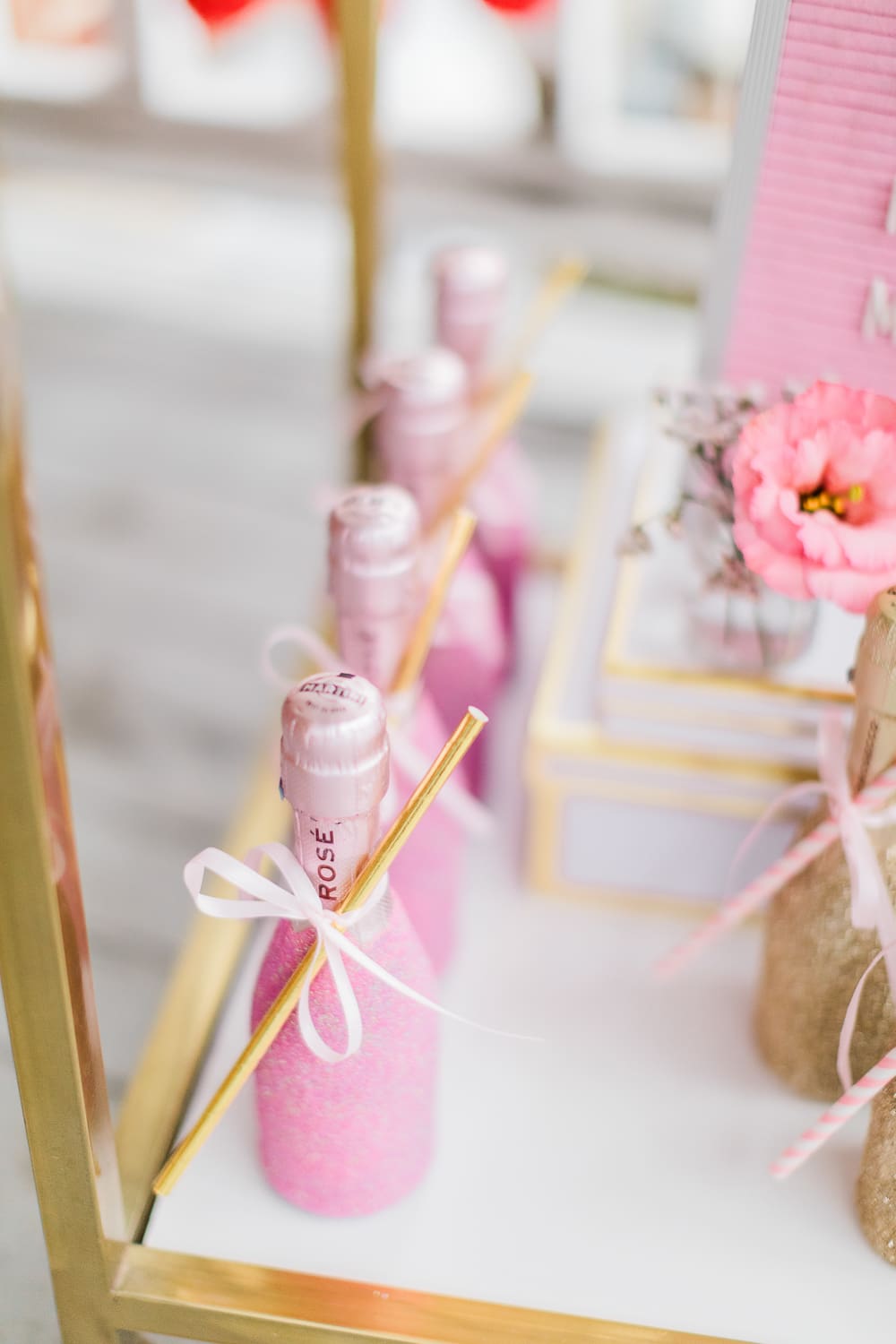 Pink glitter champagne splits displayed as party favors on southern lifestyle blogger Stephanie Ziajka's Galentine's Day bar cart Pink glitter champagne splits displayed as party favors on southern lifestyle blogger Stephanie Ziajka's Galentine's Day bar cart