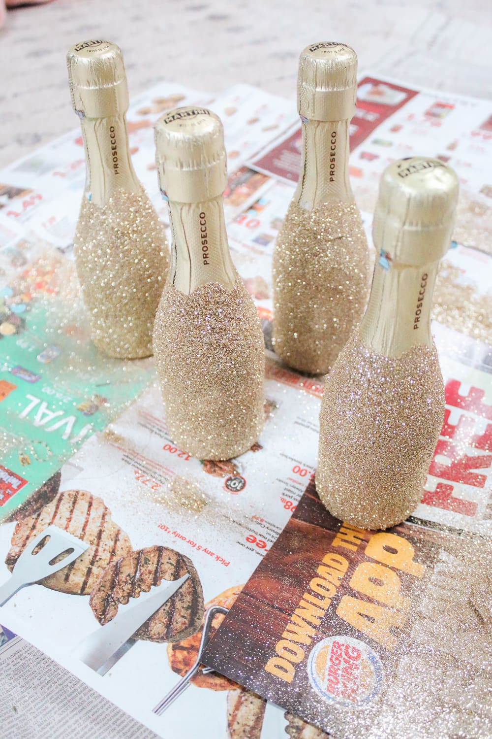 Southern lifestyle blogger Stephanie Ziajka shows how to decorate mini champagne bottles with glitter on Diary of a Debutante Southern lifestyle blogger Stephanie Ziajka shows how to decorate mini champagne bottles with glitter on Diary of a Debutante